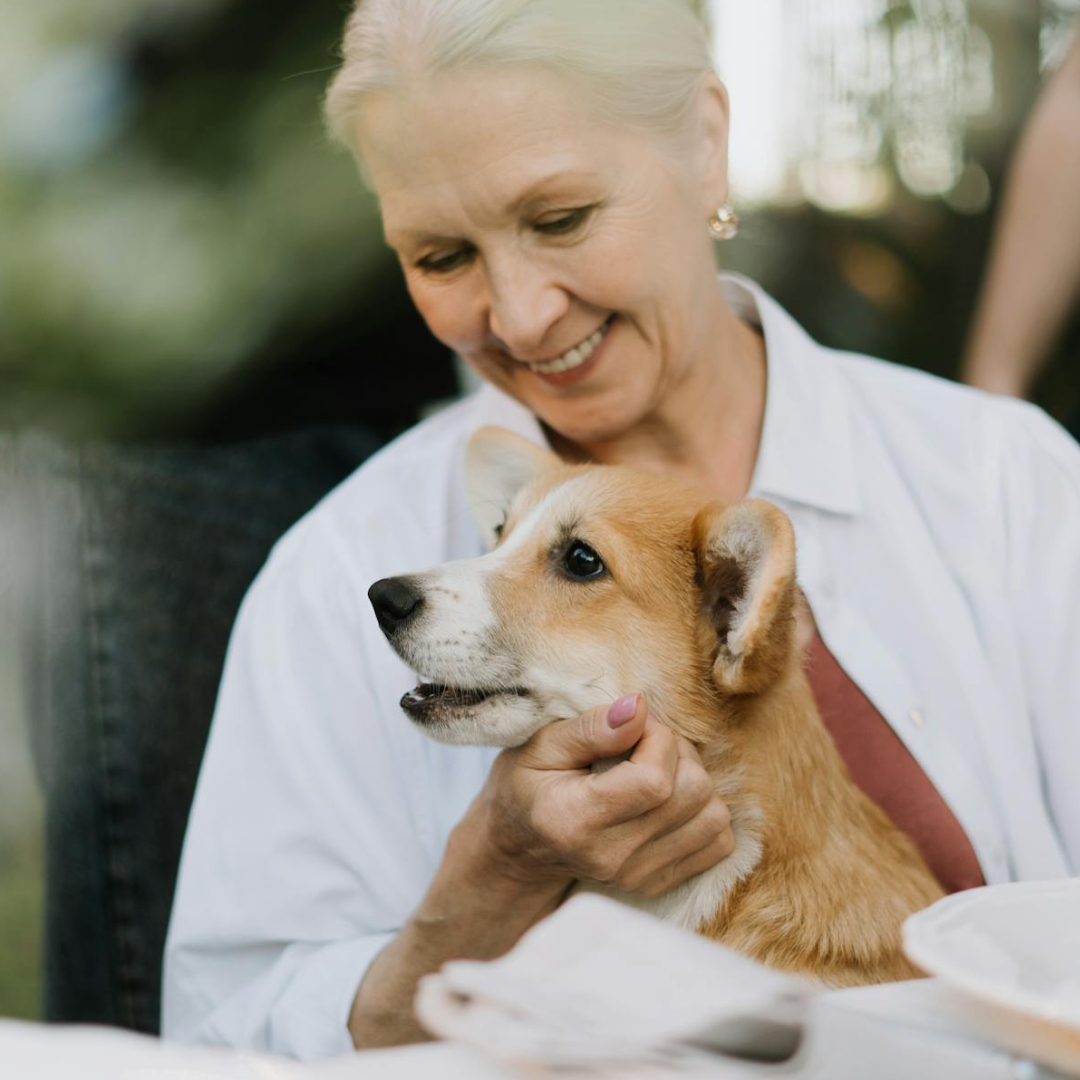 An elderly woman with her dog