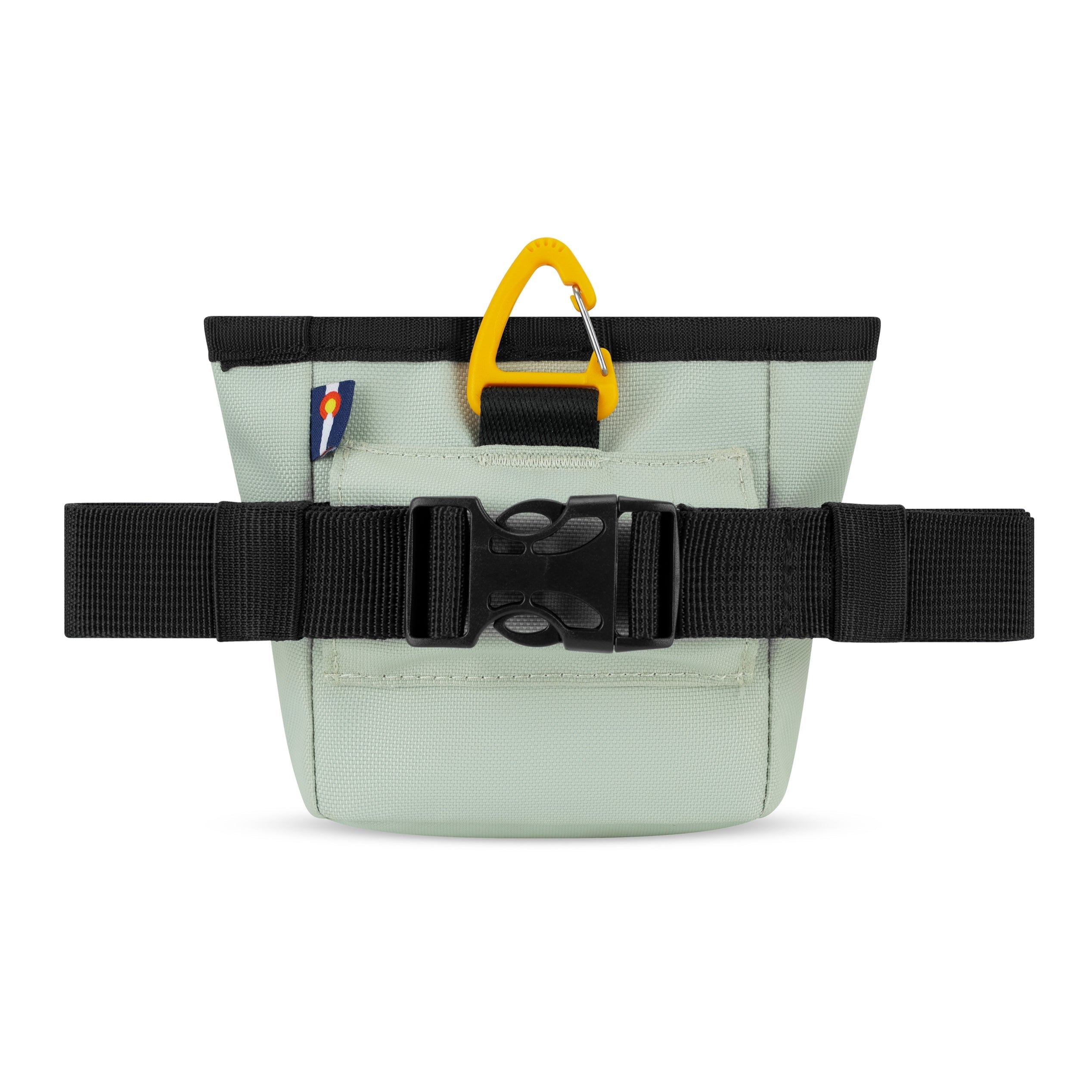 Back view of the light green OllyDog Goodie Treat Bag showing the adjustable black belt strap with buckle and a yellow carabiner clip at the top #color_celadon