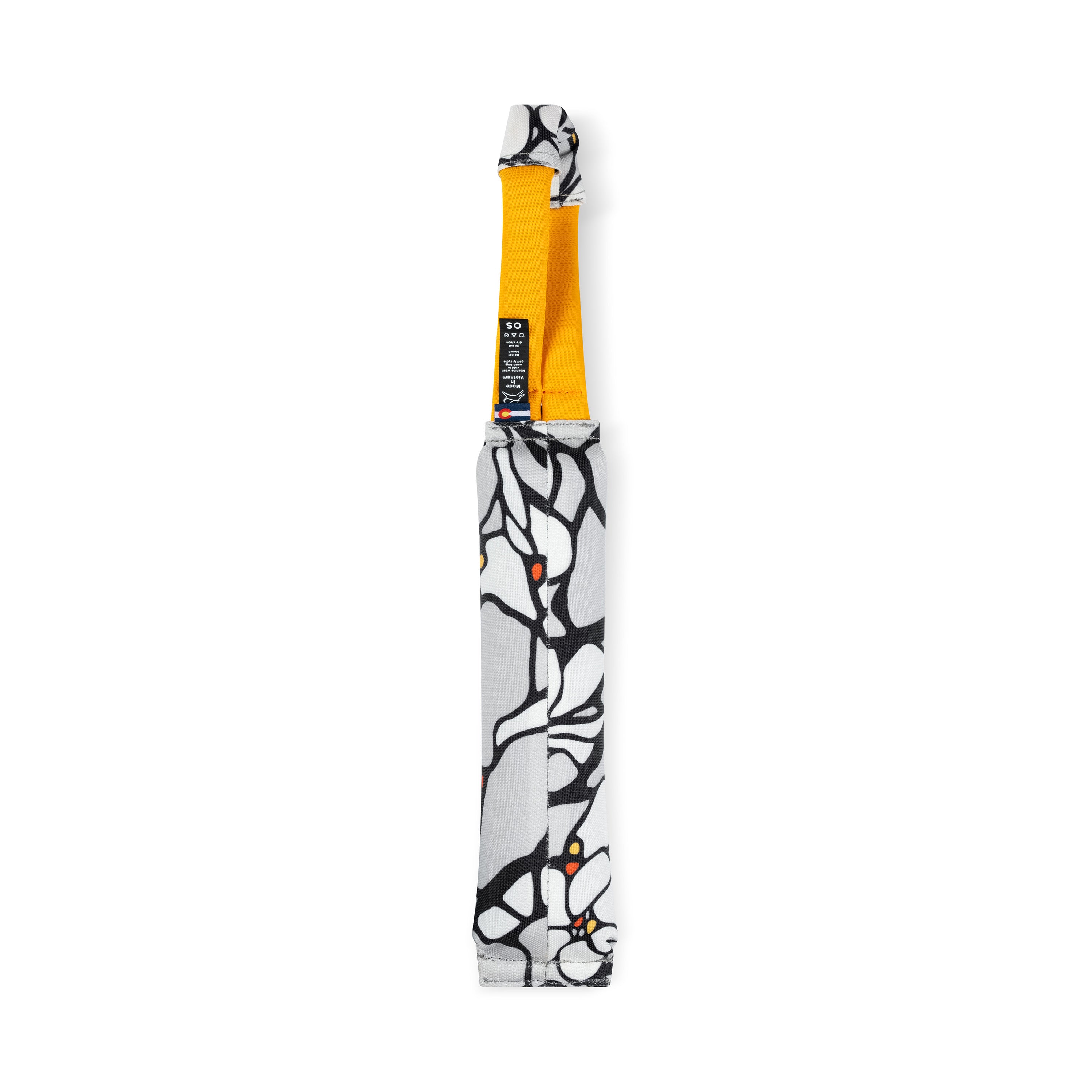 Back view of the OllyDog Tugger dog toy in Magnolia print. The floral black-and-white pattern covers the durable tug section, paired with a bright yellow handle for interactive dog play #color_magnolia