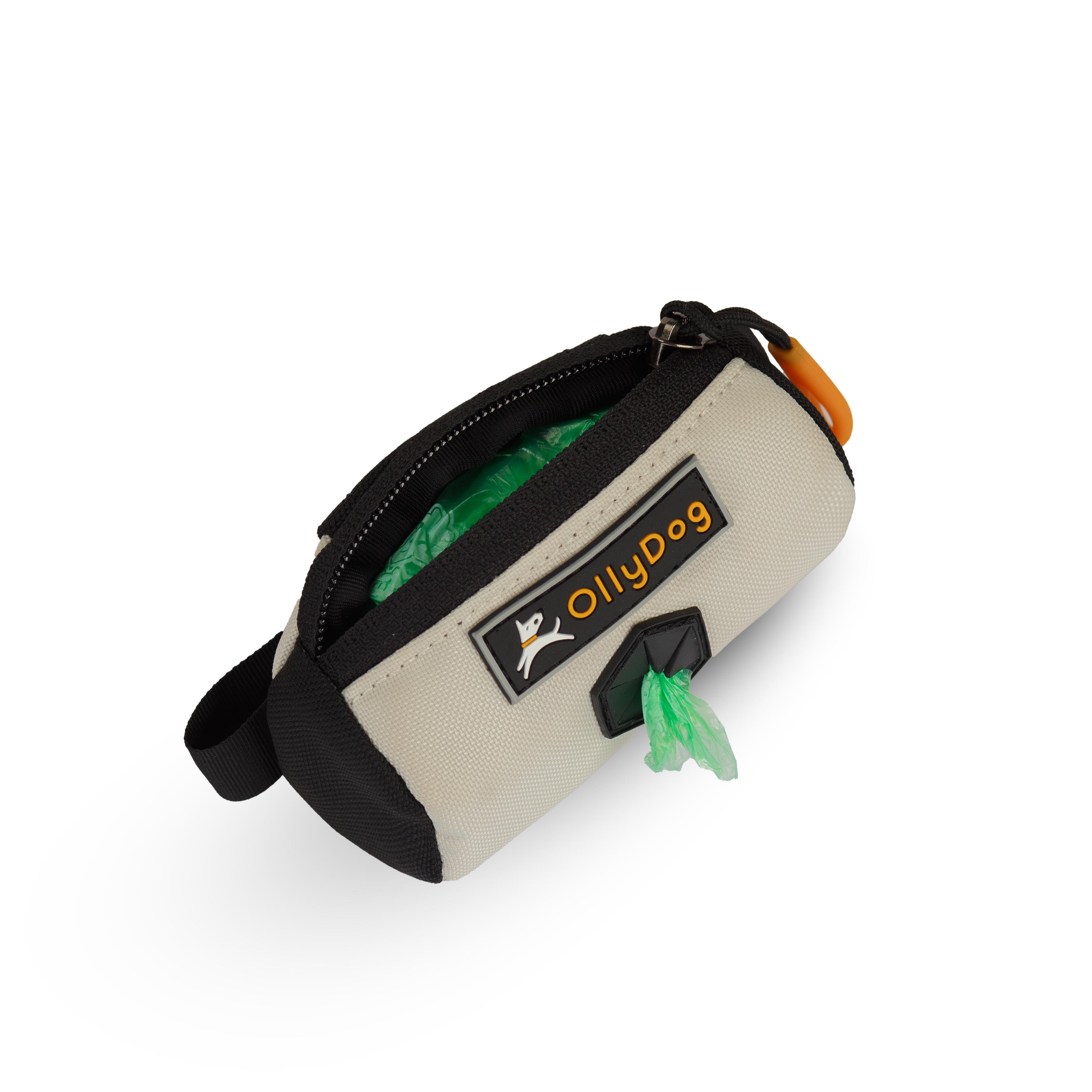 Opened view of the Scoop Pick Up Bag in Bluff. This doggy waste bag holder serves as a convenient poop bag dispenser, allowing quick access to dog poop bags on the go. The small compartment can hold standard bag rolls, keys, or a lipstick, making it a versatile doggie bag holder for leash. #color_bluff