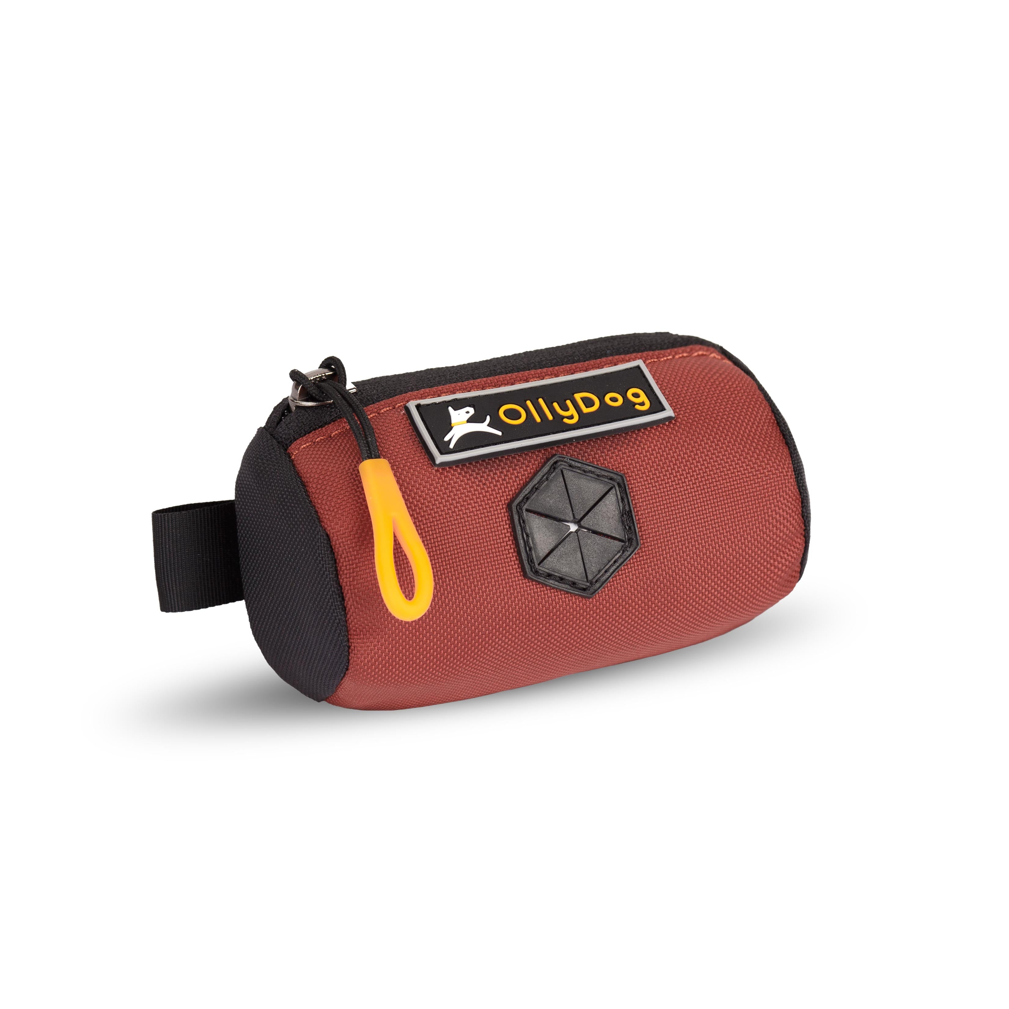Angled front view of OllyDog’s Scoop Pick Up Bag in Cider. This poop bag dispenser features a zipper closure and a snap button for quick attachment to a belt loop, making it a handy doggie bag holder for leash. The rubber dispensing cover ensures easy access to dog waste bags. #color_cider