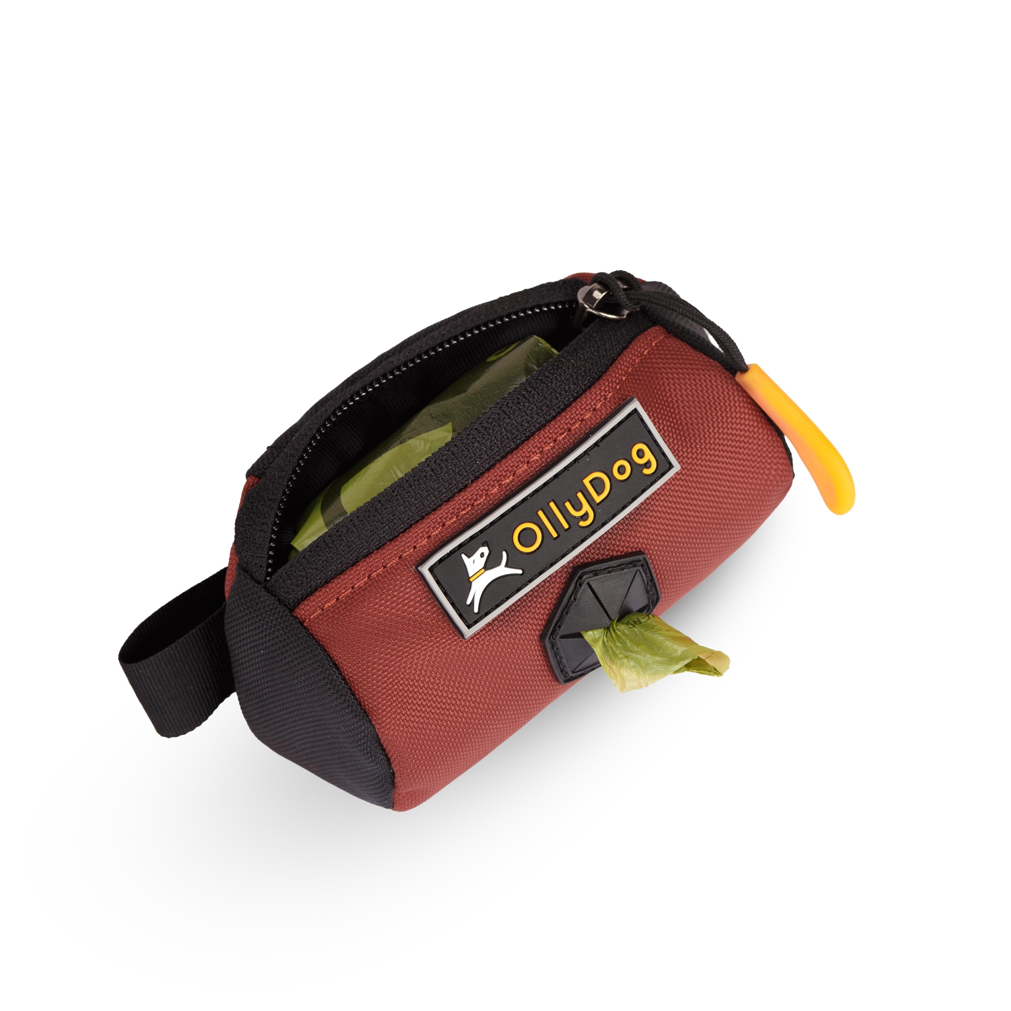 Opened view of the Scoop Pick Up Bag in Cider. This doggy waste bag holder serves as a convenient poop bag dispenser, allowing quick access to dog poop bags on the go. The small compartment can hold standard bag rolls, keys, or a lipstick, making it a versatile doggie bag holder for leash. #color_cider