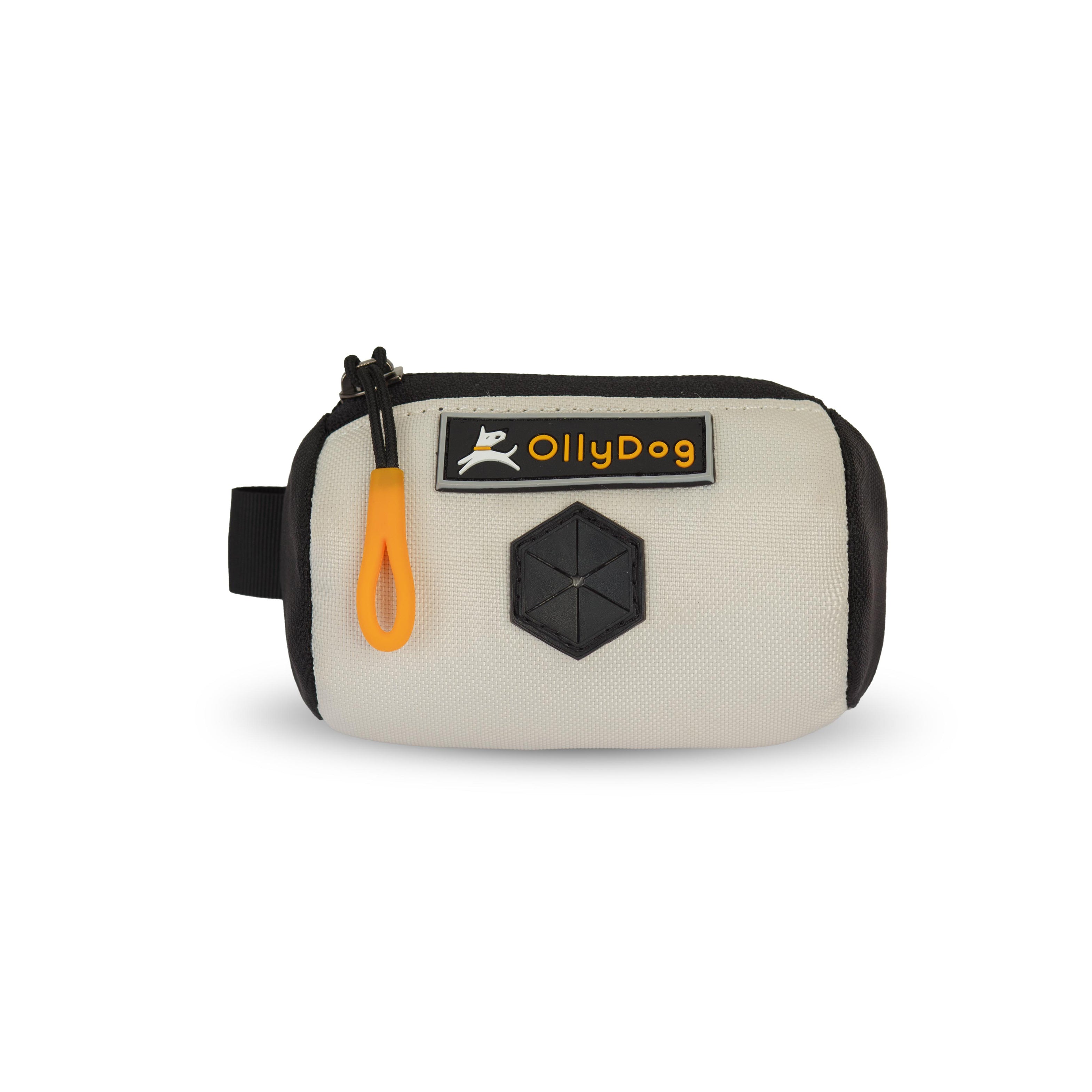 Flat front view of OllyDog’s Scoop Pick Up Bag in Bluff. This doggie poop bag holder features a zipper closure, a snap button for quick attachment to a belt loop, and a rubber dispensing cover, making it an ideal doggie bag holder for leash. #color_bluff