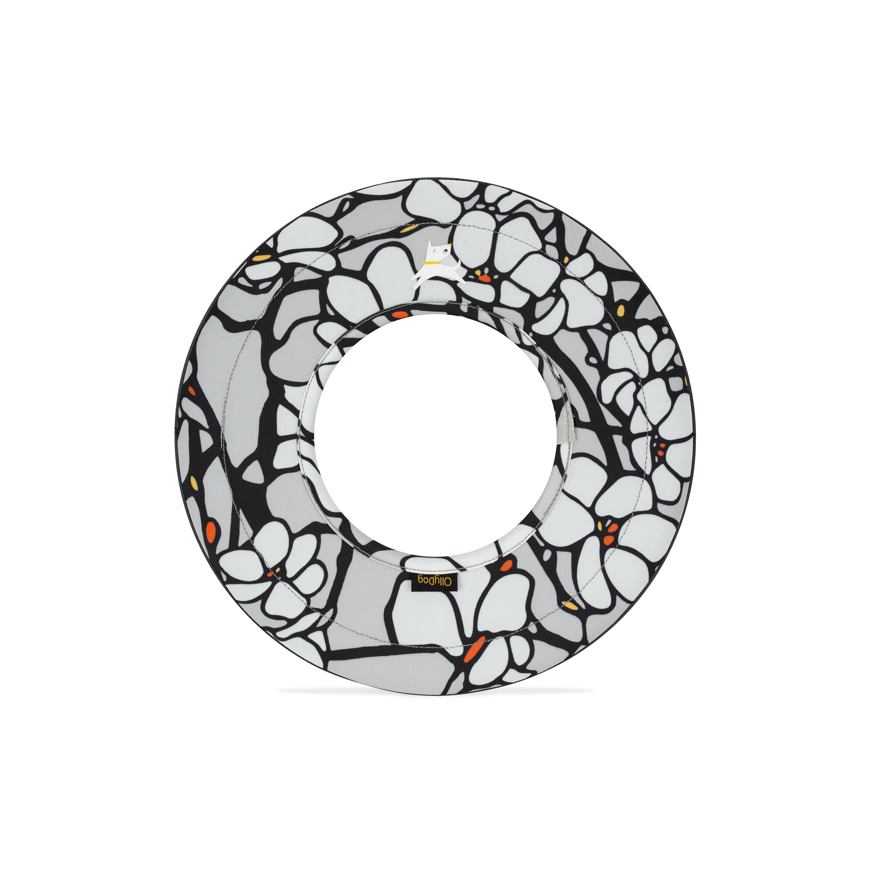 Front view of Magnolia Super Flyer dog frisbee featuring bold black and white floral pattern with orange accents, and central cutout for fetch play #color_magnolia