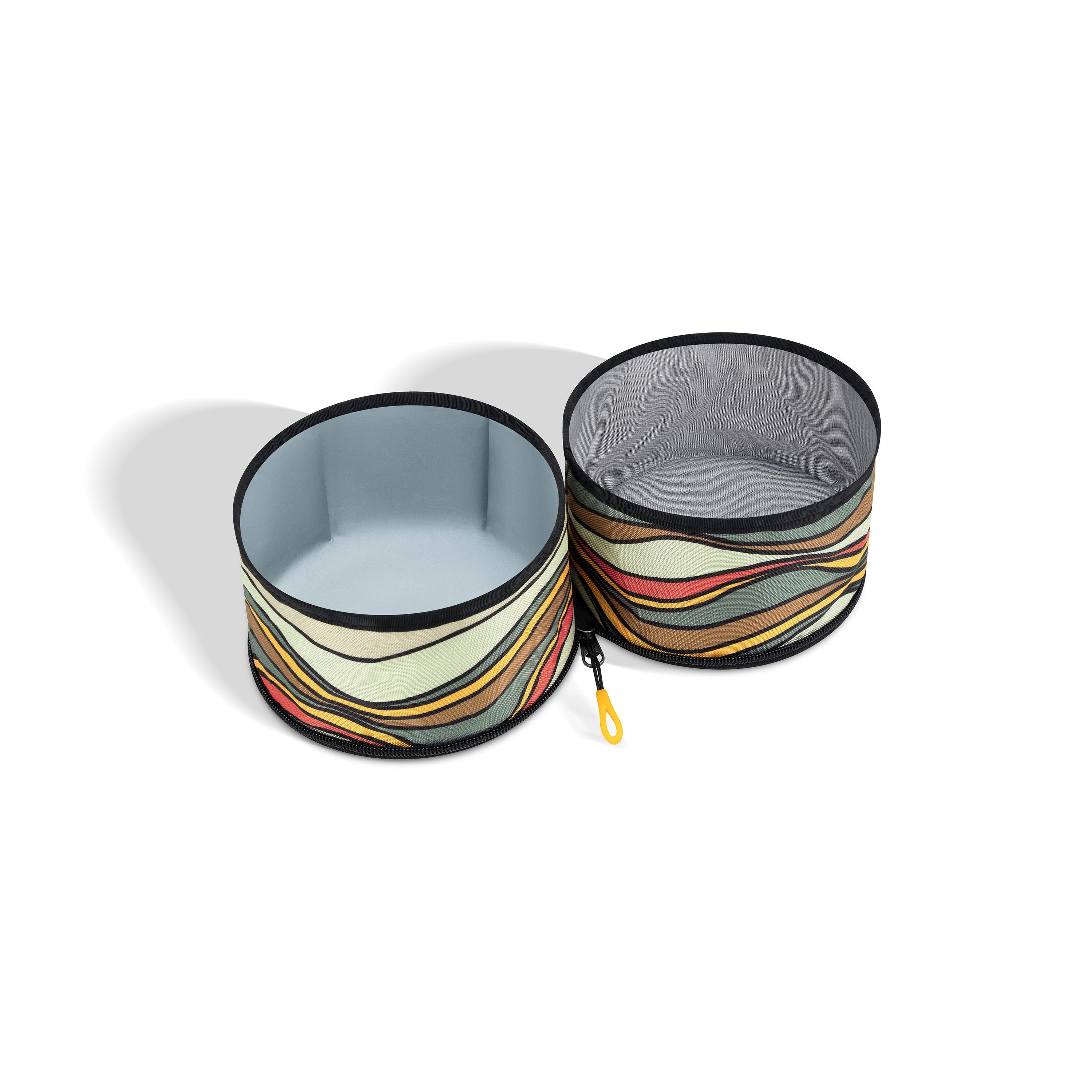 Two Ventura '73 collapsible dog bowls connected by fabric, featuring a retro horizontal striped pattern in shades of brown, cream, yellow, and black. A yellow attachment loop is visible #color_ventura '73