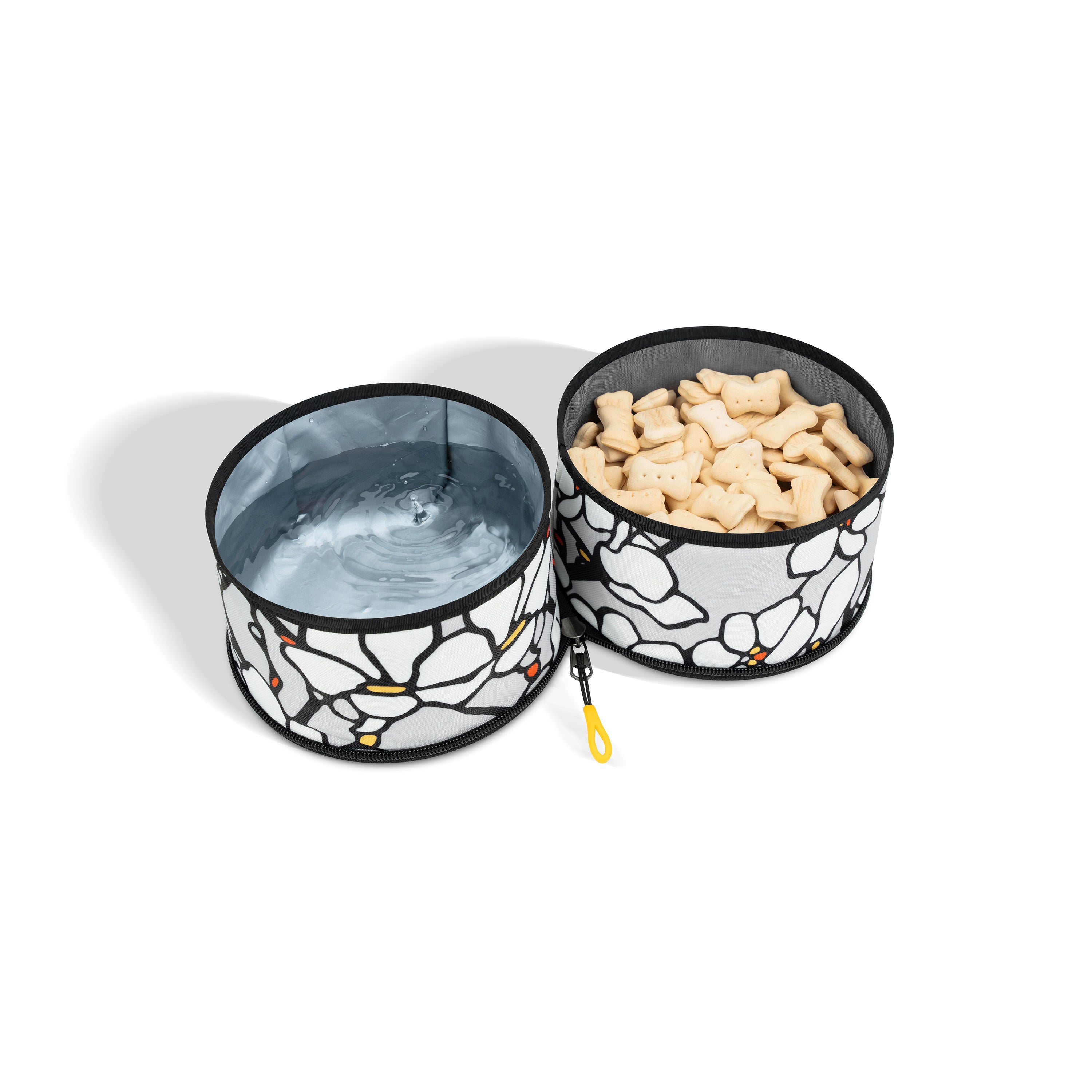 Collapsible fabric dog bowl with two compartments and a floral pattern, designed for carrying both food and water for dogs during travel #color_magnolia