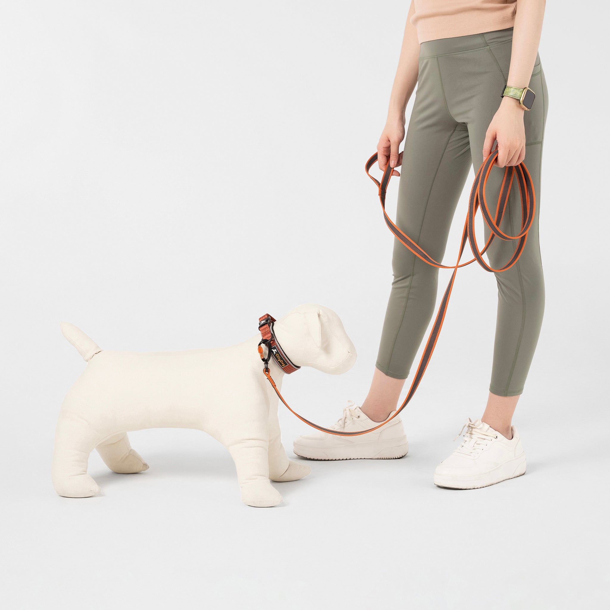 OllyDog Rubber Grip Reflective Dog Leash in Clay Orange - 119" long durable leash shown with mannequin dog and model against white background, featuring reflective trim for safety
 #color_clay