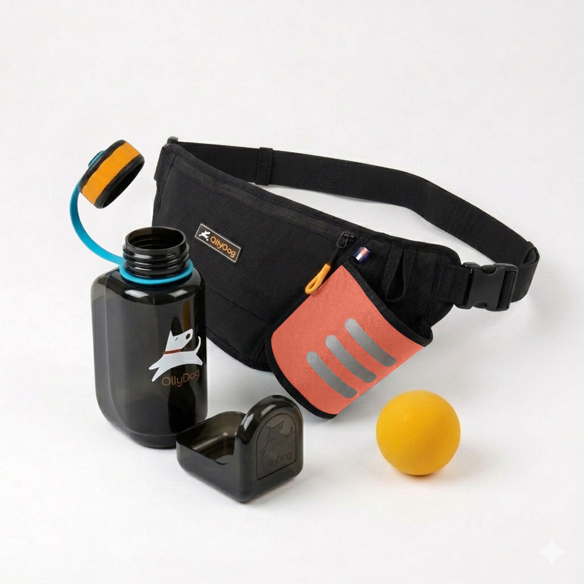 OllyDog dog adventure bundle featuring a black Hydro-Slim fanny pack with a Flame red accent pocket, a Smoke black portable OllyBottle with teal accents and a detachable drinking bowl, and a yellow rubber Happy Camper ball