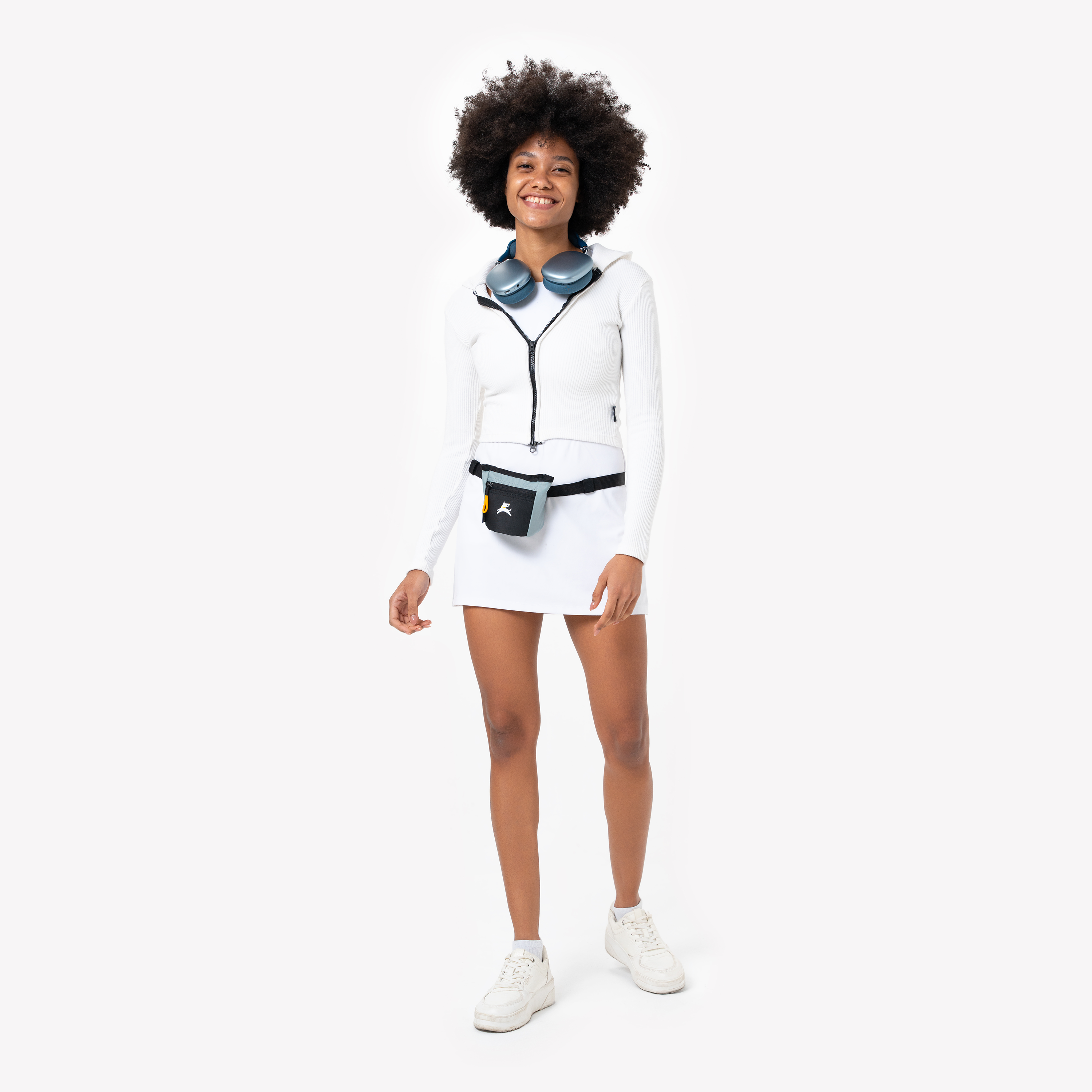 Lifestyle shot of a person wearing the OllyDog Goodie Treat Bag in st. lucia color around their waist against a white background. #color_st. lucia