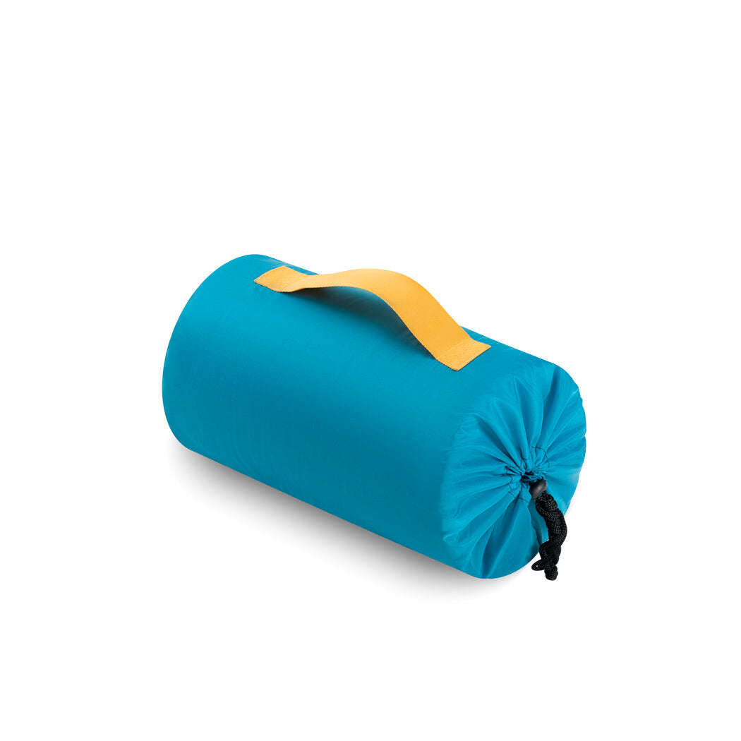 OllyDog Meeker Dog Sleeping Bag rolled up inside its blue drawstring storage bag with yellow handle, showing compact, lightweight design for easy carrying