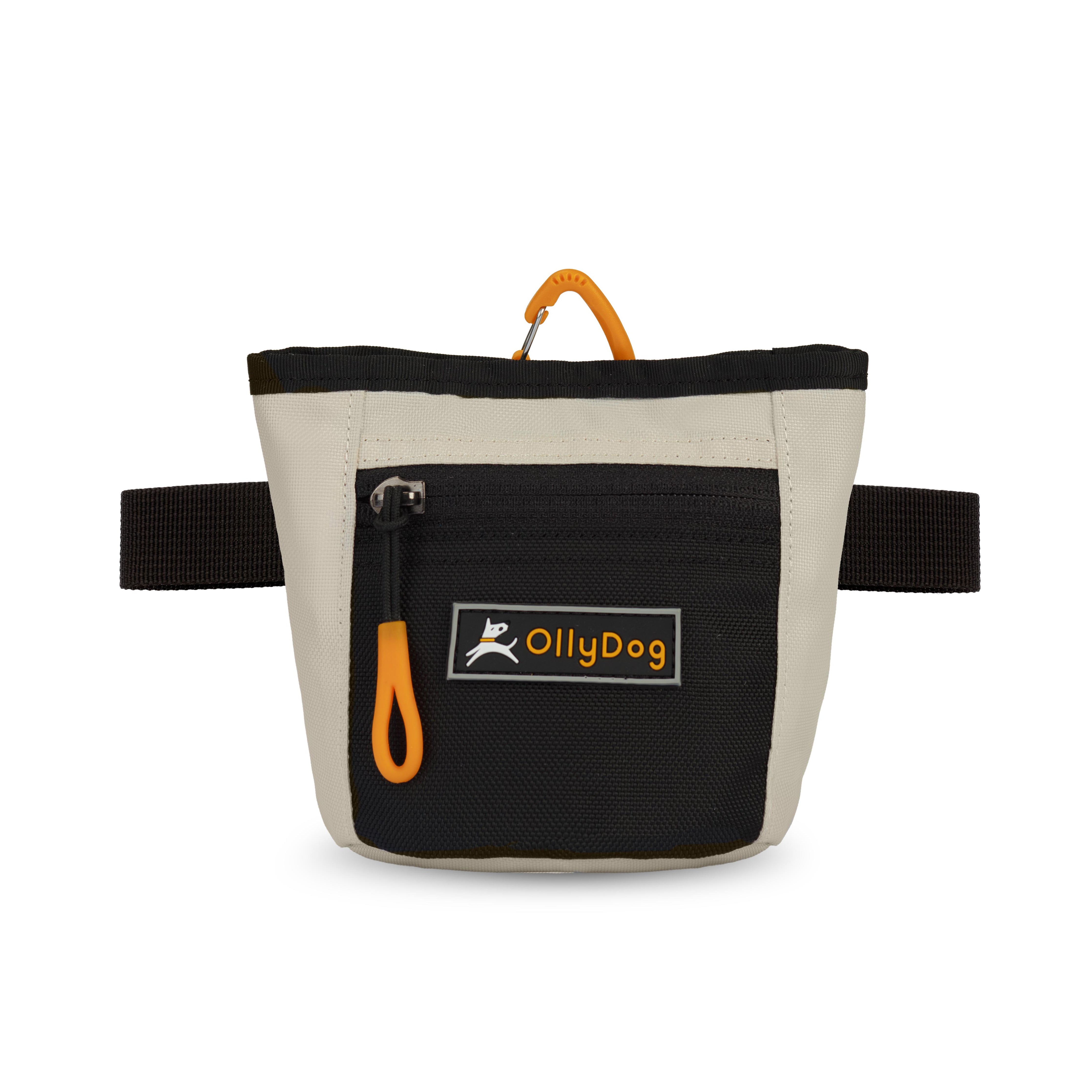 Flat front view of OllyDog’s Goodie Treat Bag in Bluff. The dog treat pouch includes a magnetic closure on the main compartment, a front zipper pocket, and an adjustable waist strap for hands-free dog training. #color_bluff