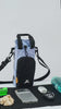 Close-up video showing a person opening the quick-access front zipper pocket filled with pet treats on the OllyDog OllyCaddy dog walking carryall in Blue Heron color.