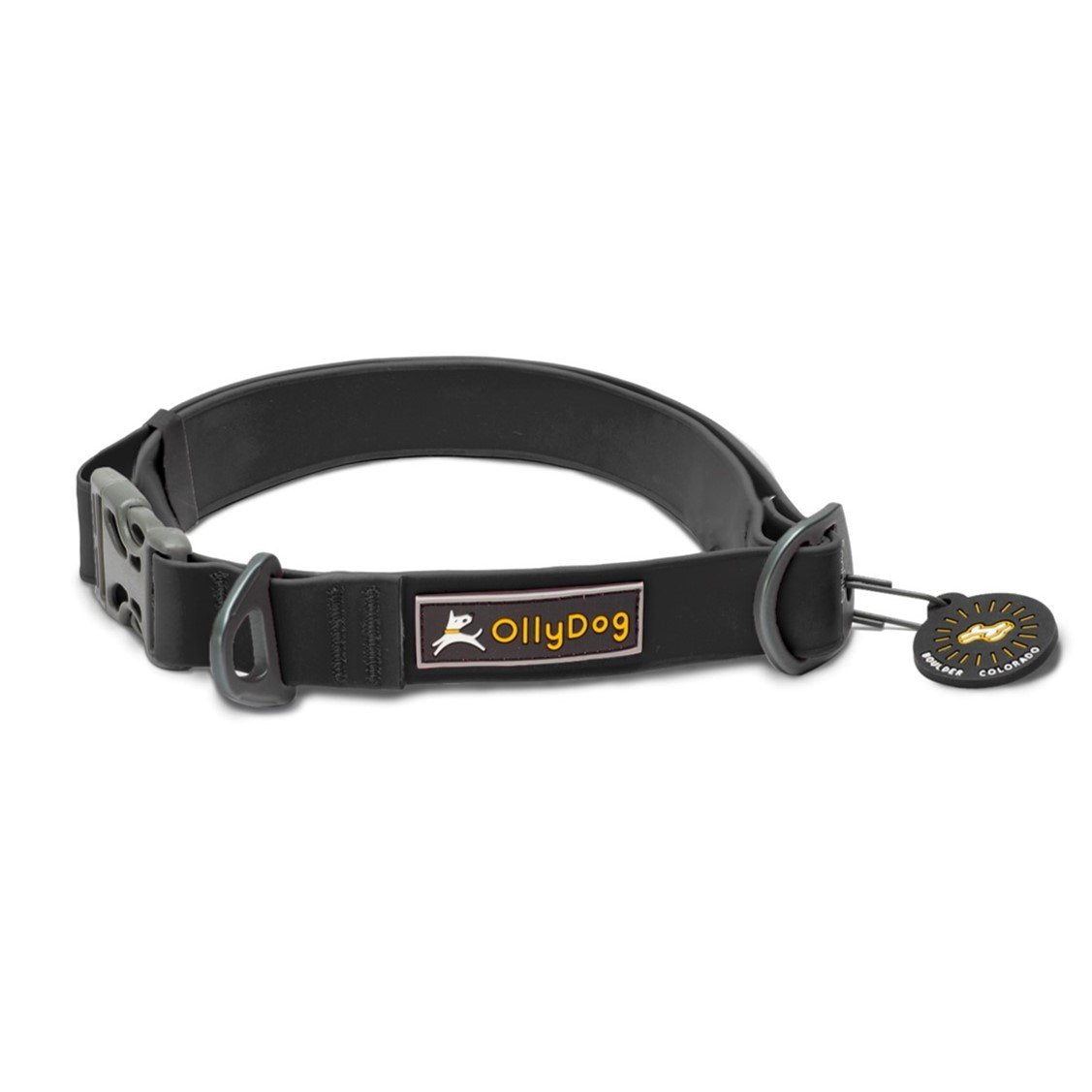 Front view of the OllyDog Tilden Waterproof Collar in black color, featuring waterproof AquaGuard coating, an easy-releasing plastic side-buckle, a secure aluminum D-ring, the OllyDog brand label, and an attached Boulder Colorado tag. #color_black