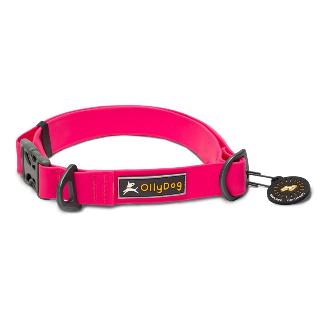 Front view of the OllyDog Tilden Waterproof Collar in pink color, featuring waterproof AquaGuard coating, an easy-releasing plastic side-buckle, a secure aluminum D-ring, the OllyDog brand label, and an attached Boulder Colorado tag. #color_pink